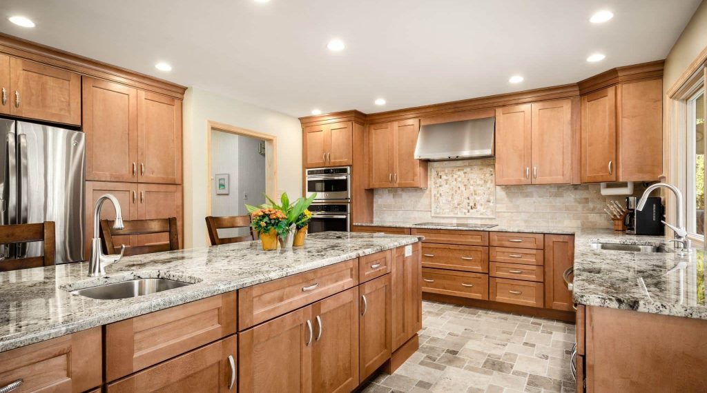 Kitchen in Berwyn, PA designed by Main Line Kitchen Design and featuring Bishop Utica birch door style cabinetry in a light finish.