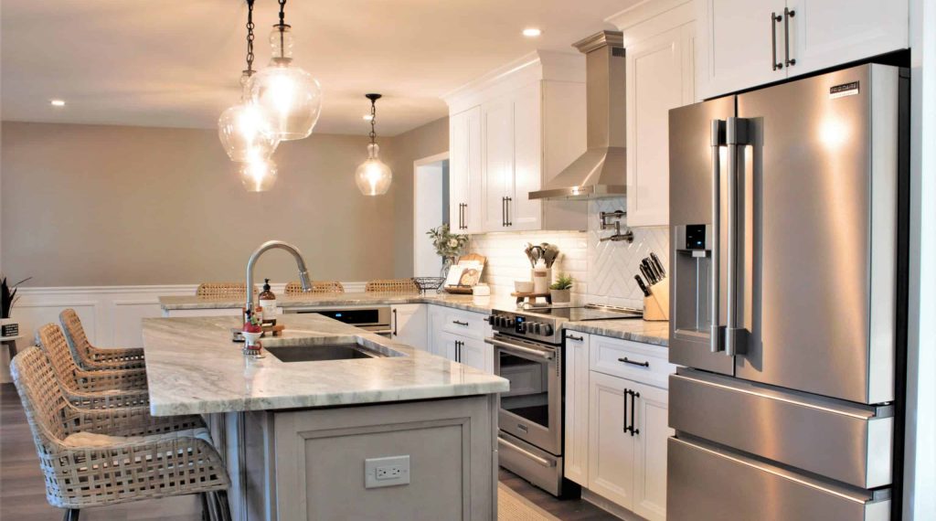 White and gray kitchen designed by Main Line Kitchen Design in Media, PA featuring Fabuwood Onyx Frost cabinets and a Horizon stained island with Quartzite countertop.