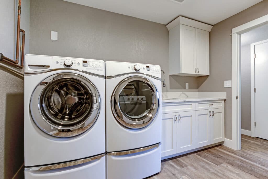 Pedestals for washers and dryers are common design mistakes that kill space while people believe they are increasing it.